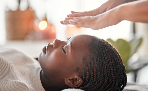 child receiving energy healing in serene environment with gentle touch and calming atmosphere