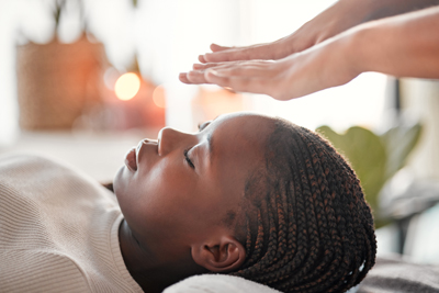 person receiving energy healing therapy in a calming environment with candles and plants promoting relaxation and wellness techniques 9 benefits of healing energy