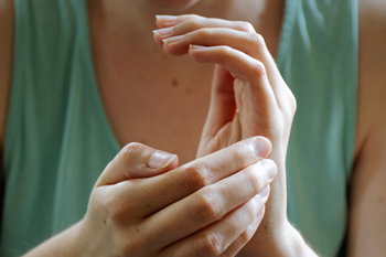 hands gently clasping in a soothing manner promoting relaxation techniques for overall wellness with five key benefits